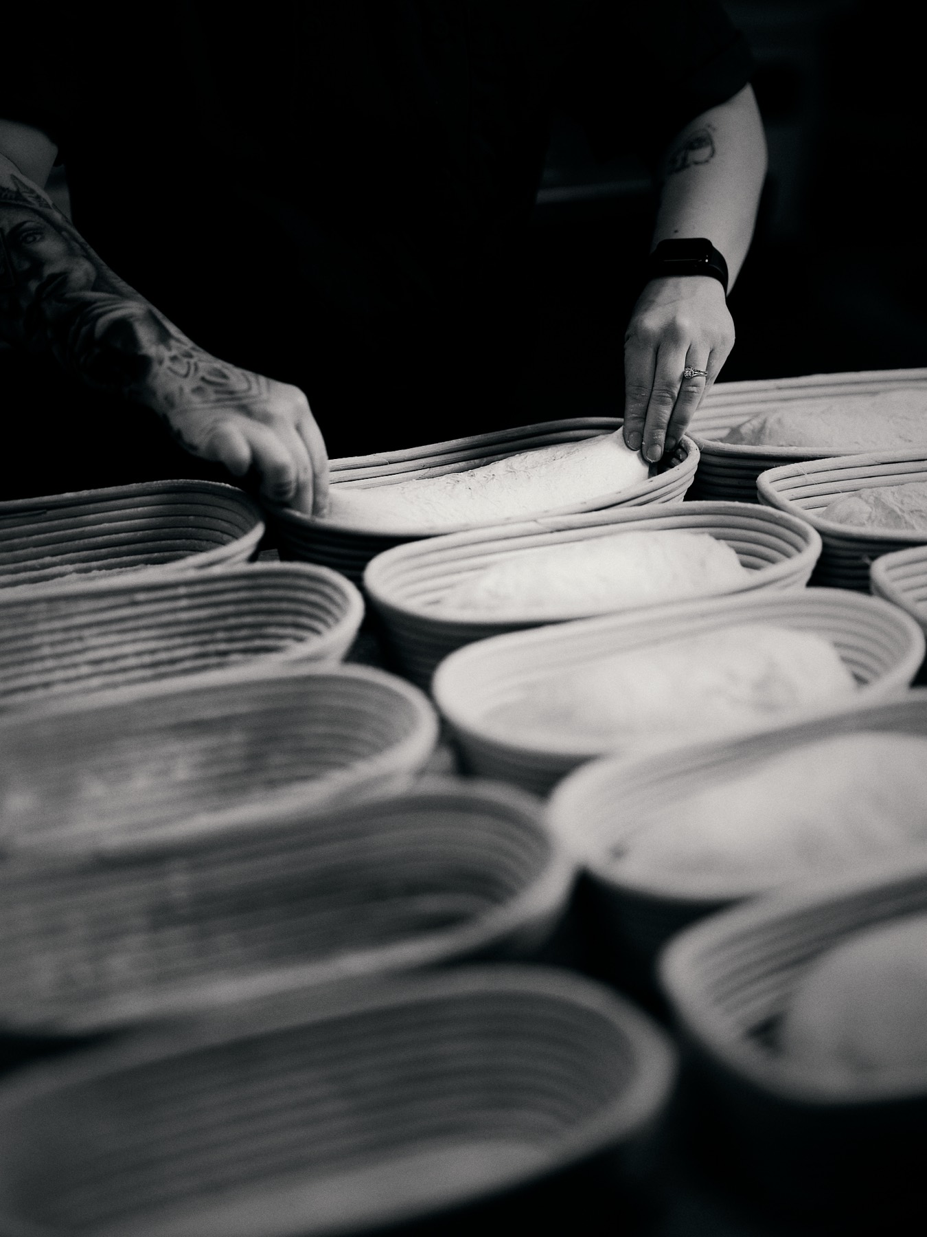 Baker arranging proofing baskets